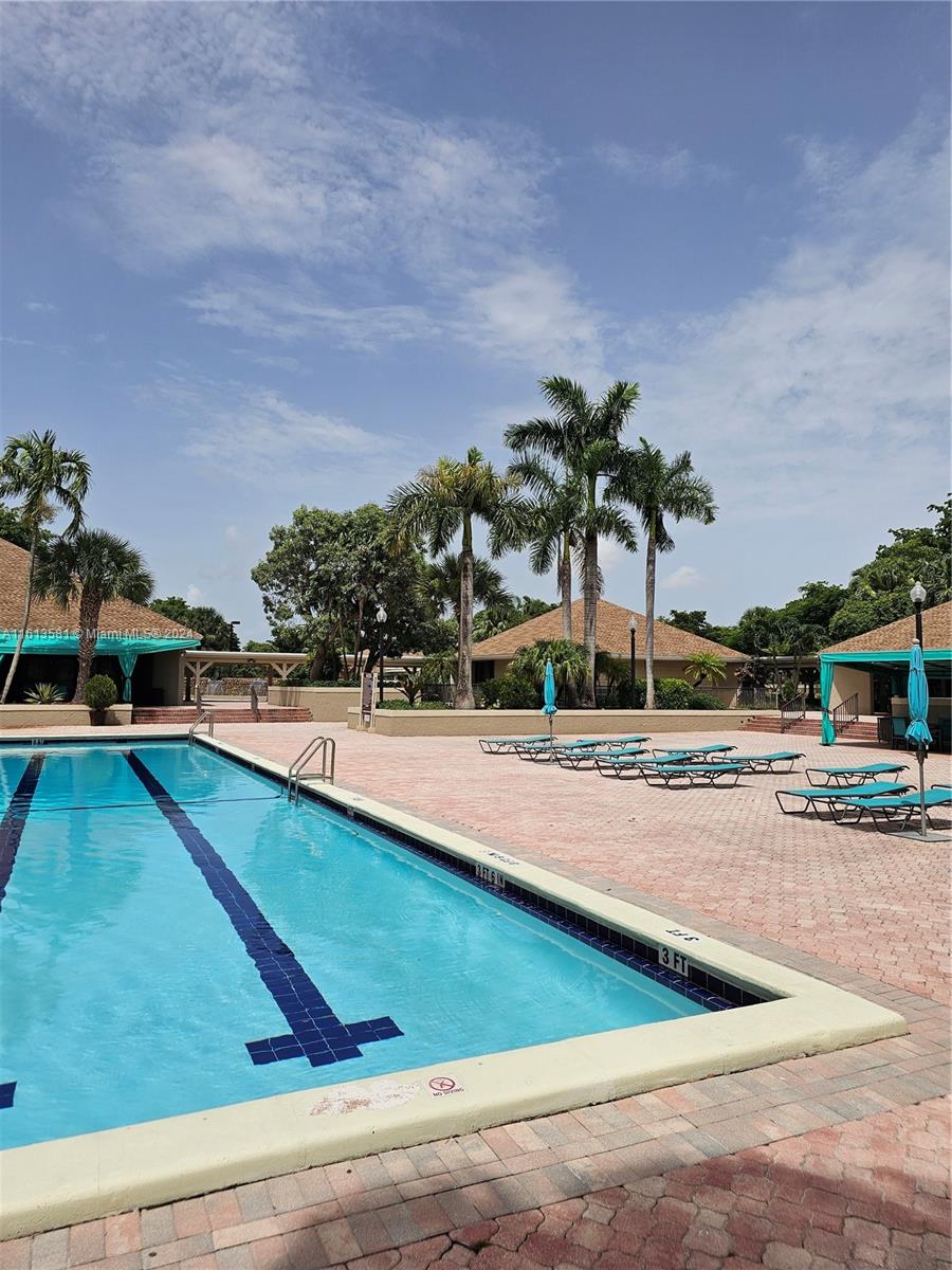 4323 Southwest 148th Place Miami, FL 33185 - Photo 53 of 70 a view of a swimming pool with an outdoor seating