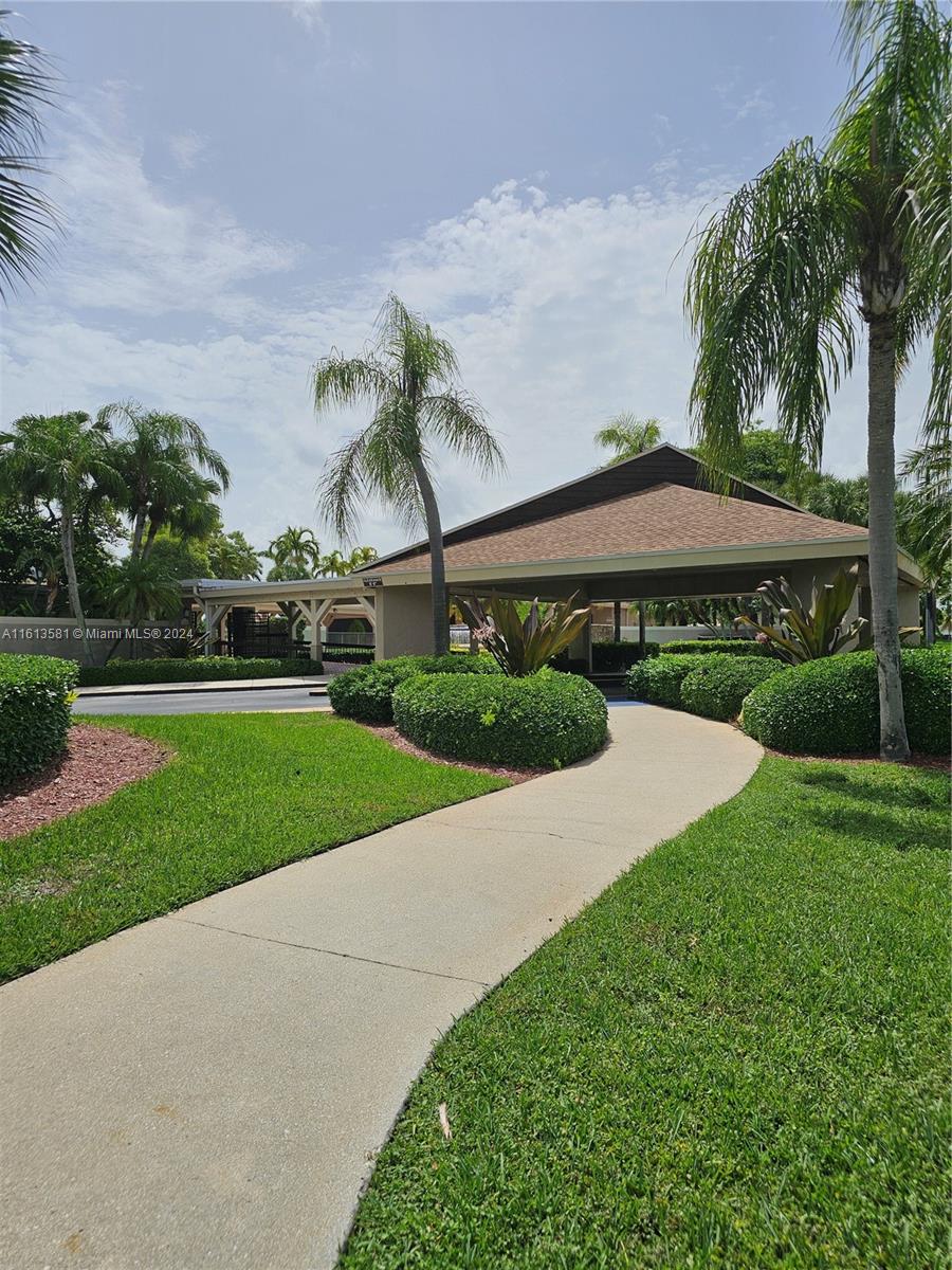 4323 Southwest 148th Place Miami, FL 33185 - Photo 69 of 70 a view of a garden with a table and chairs under an umbrella