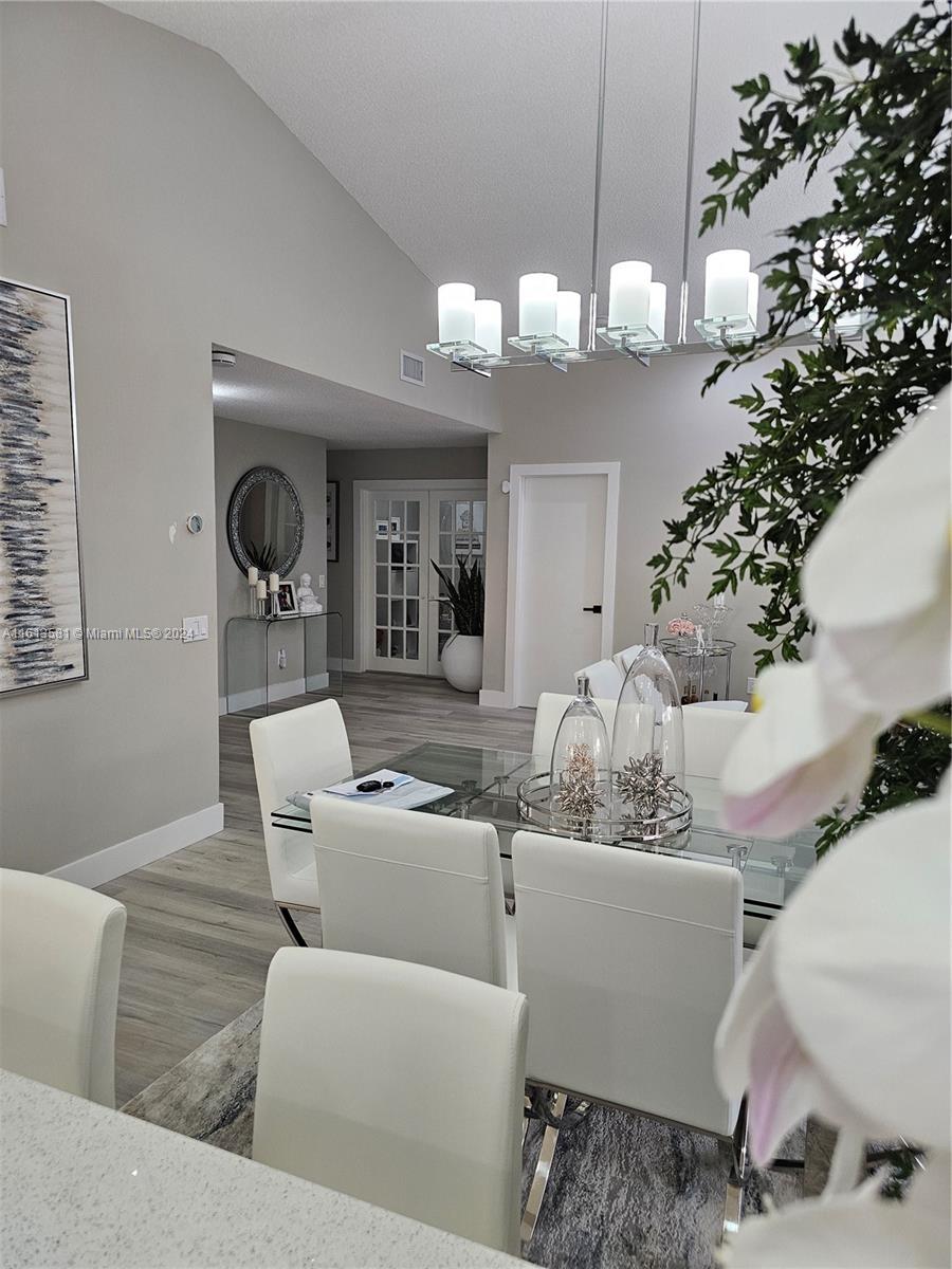 4323 Southwest 148th Place Miami, FL 33185 - Photo 8 of 70 a living room with furniture and a chandelier