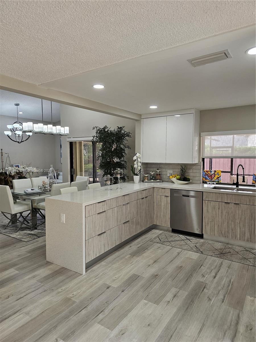 4323 Southwest 148th Place Miami, FL 33185 - Photo 9 of 70 a kitchen with a sink stainless steel appliances and cabinets