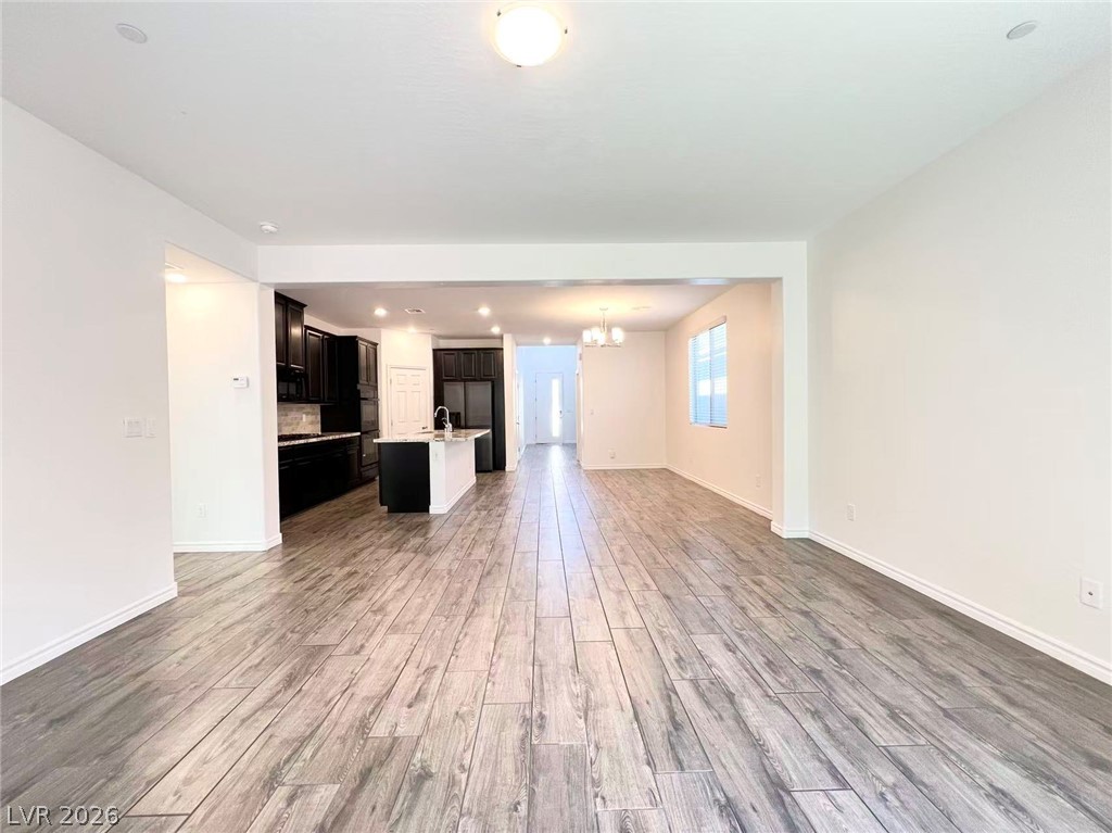 925 Bayberry Ridge Street Henderson, NV 89052 - Photo 2 of 27 Seamless flow between living spaces with durable wood-look tile flooring.