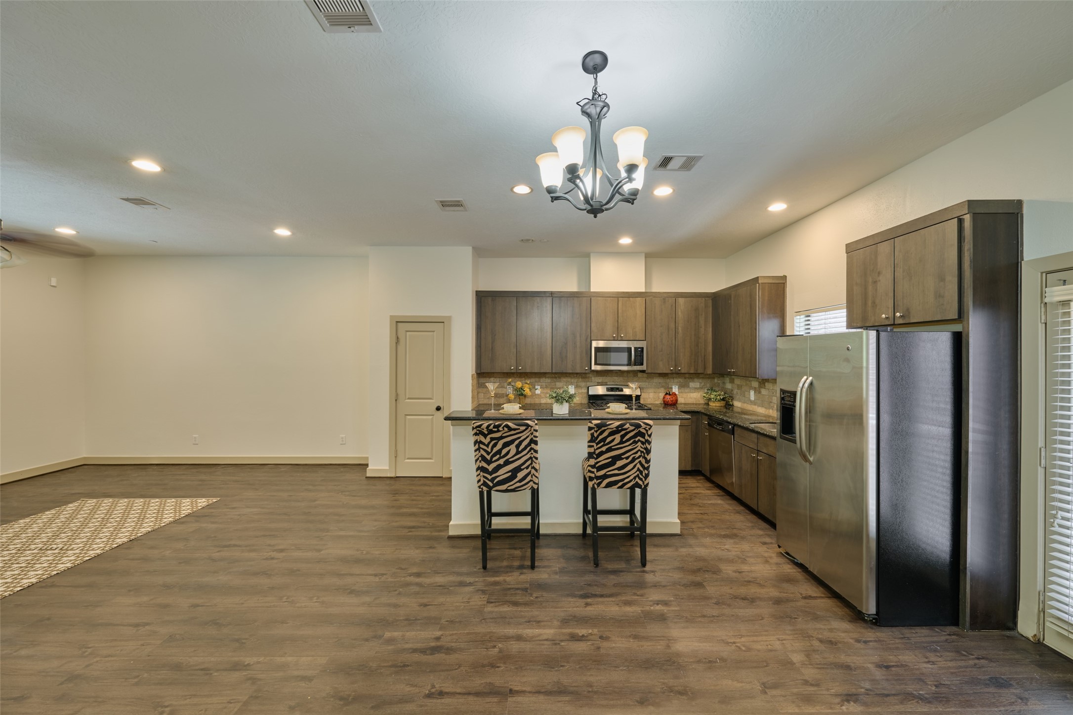2422 Navigation Boulevard, Unit E Houston, TX 77003 - Photo 7 of 29 a view of a kitchen with refrigerator and chairs