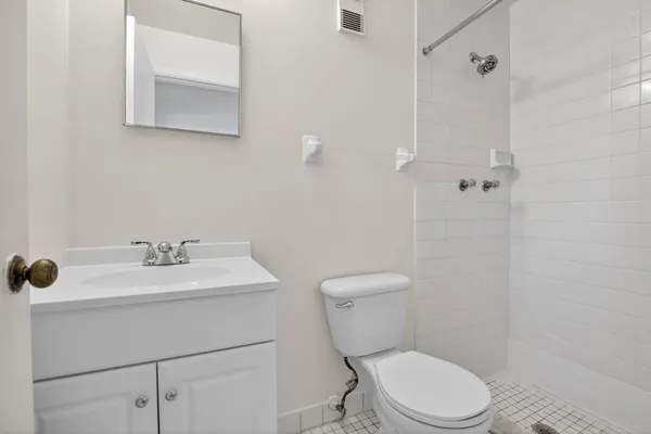 a white toilet sitting next to a bathroom sink