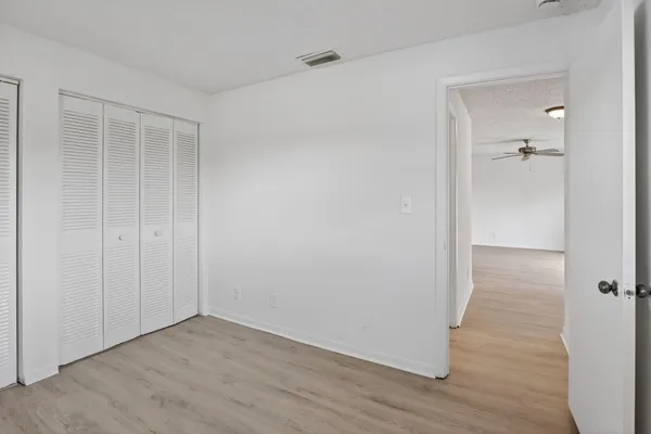 a view of a room with wooden floor