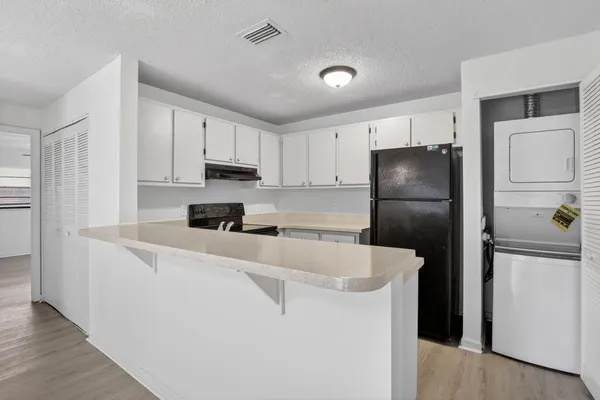 a kitchen with a refrigerator a stove and a refrigerator