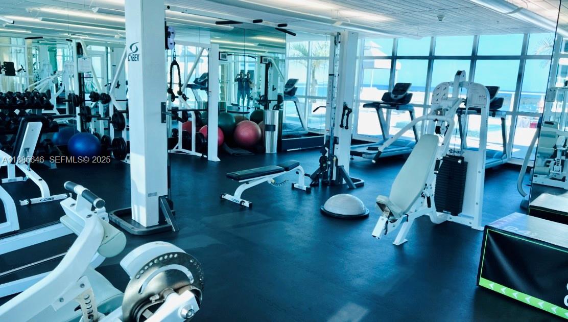218 Southeast 14th Street, Unit 1504 Miami, FL 33131 - Photo 14 of 15 a view of a room with gym equipment