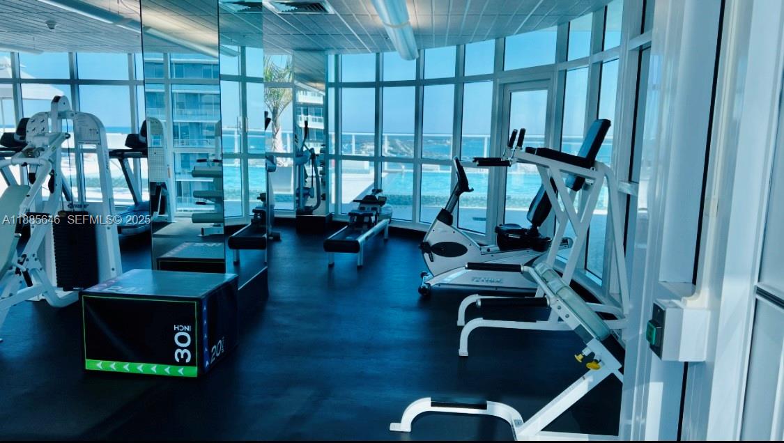 218 Southeast 14th Street, Unit 1504 Miami, FL 33131 - Photo 15 of 15 a view of gym equipment with living room