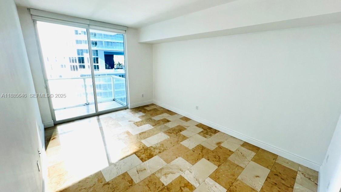 218 Southeast 14th Street, Unit 1504 Miami, FL 33131 - Photo 6 of 15 an empty room with windows