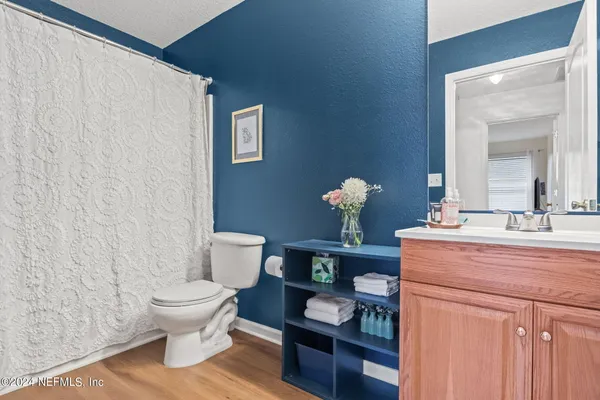 a bathroom with a sink mirror and toilet