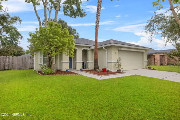 a view of a house with backyard and sitting area