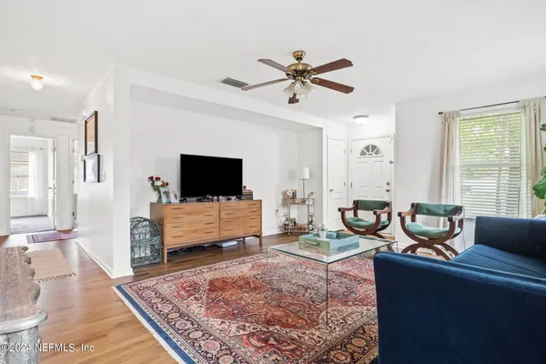 a living room with furniture and a flat screen tv