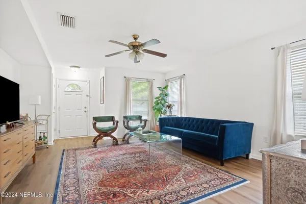 a living room with furniture and a flat screen tv