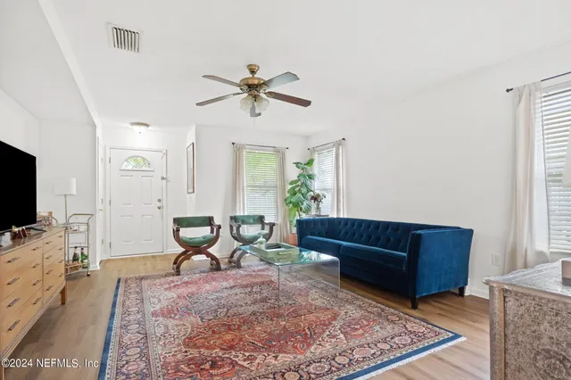 a living room with furniture and a flat screen tv