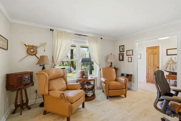 a living room with a bed furniture and a window