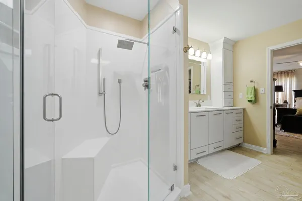 a spacious bathroom with a double vanity sink mirror and shower