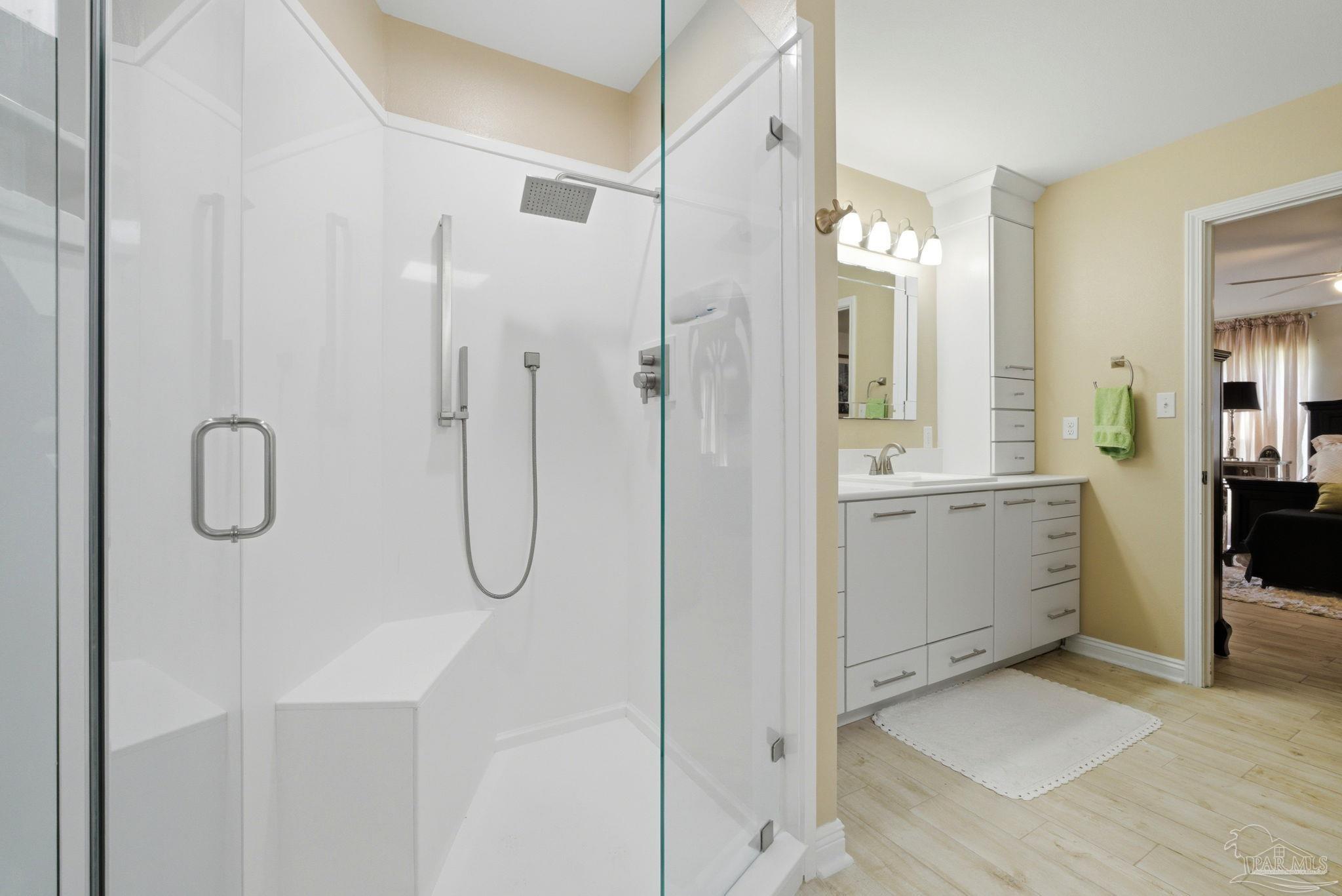 6550 Chardonnay Pensacola, FL 32504 - Photo 20 of 42 a bathroom with a double vanity sink a mirror a shower and a bathtub