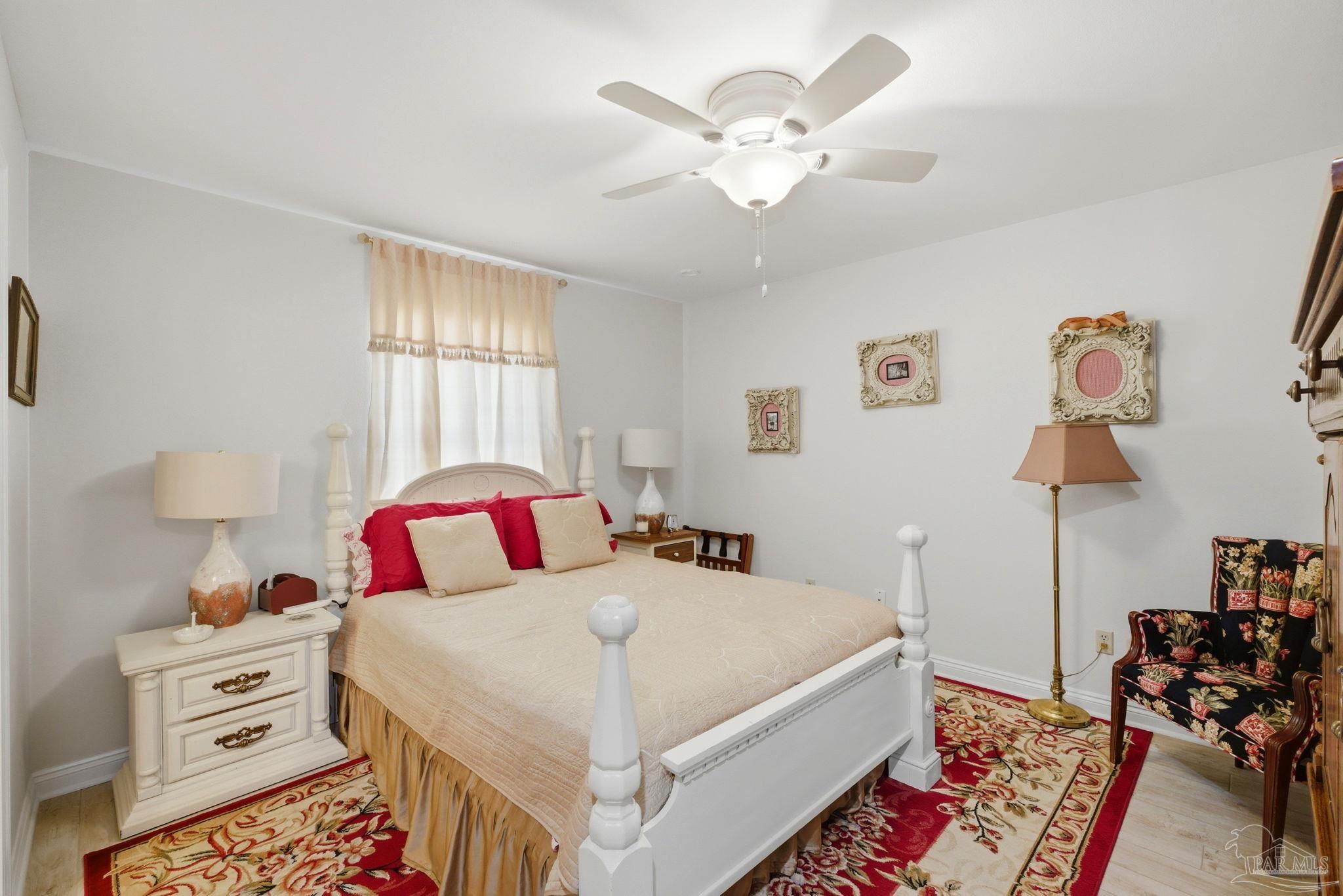 6550 Chardonnay Pensacola, FL 32504 - Photo 22 of 42 a bedroom with a bed and a chandelier