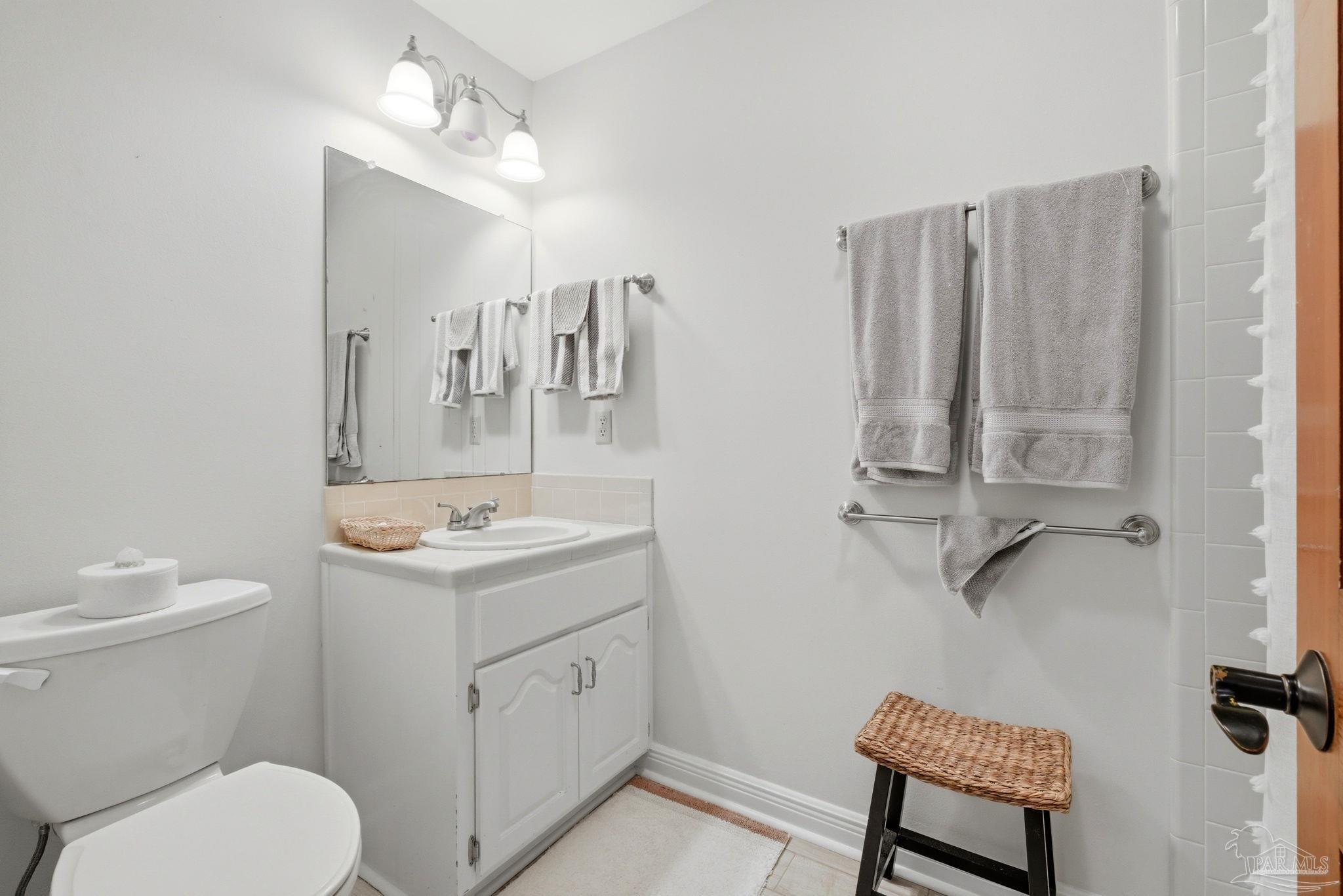 6550 Chardonnay Pensacola, FL 32504 - Photo 24 of 42 a bathroom with a toilet a sink and a mirror