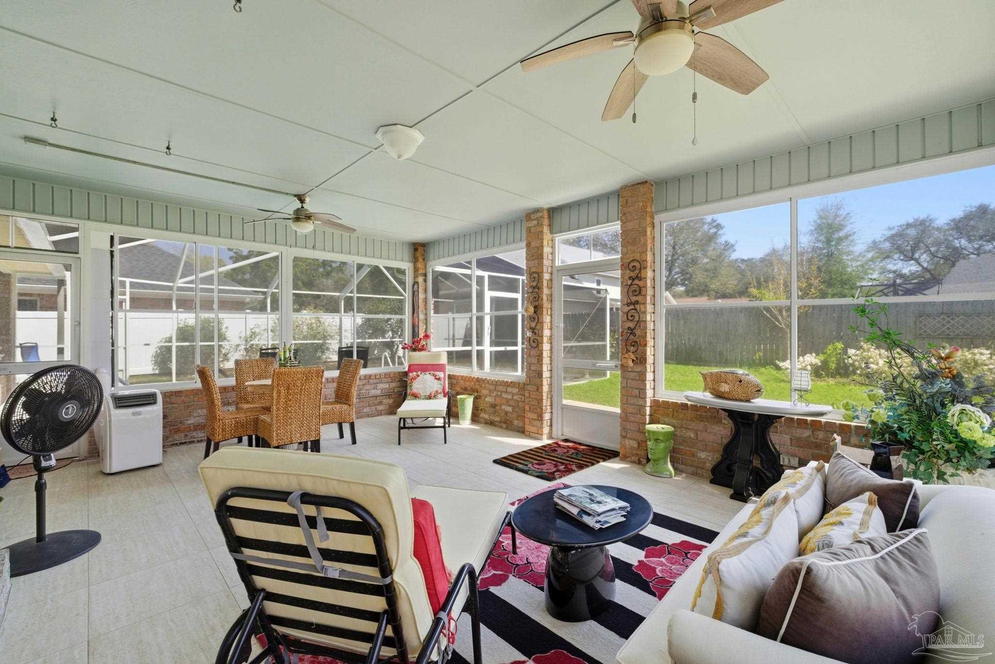 6550 Chardonnay Pensacola, FL 32504 - Photo 33 of 42 a living room with furniture and a floor to ceiling window