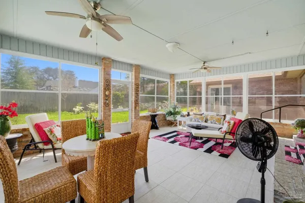 a view of a patio with a table and chairs under an umbrella