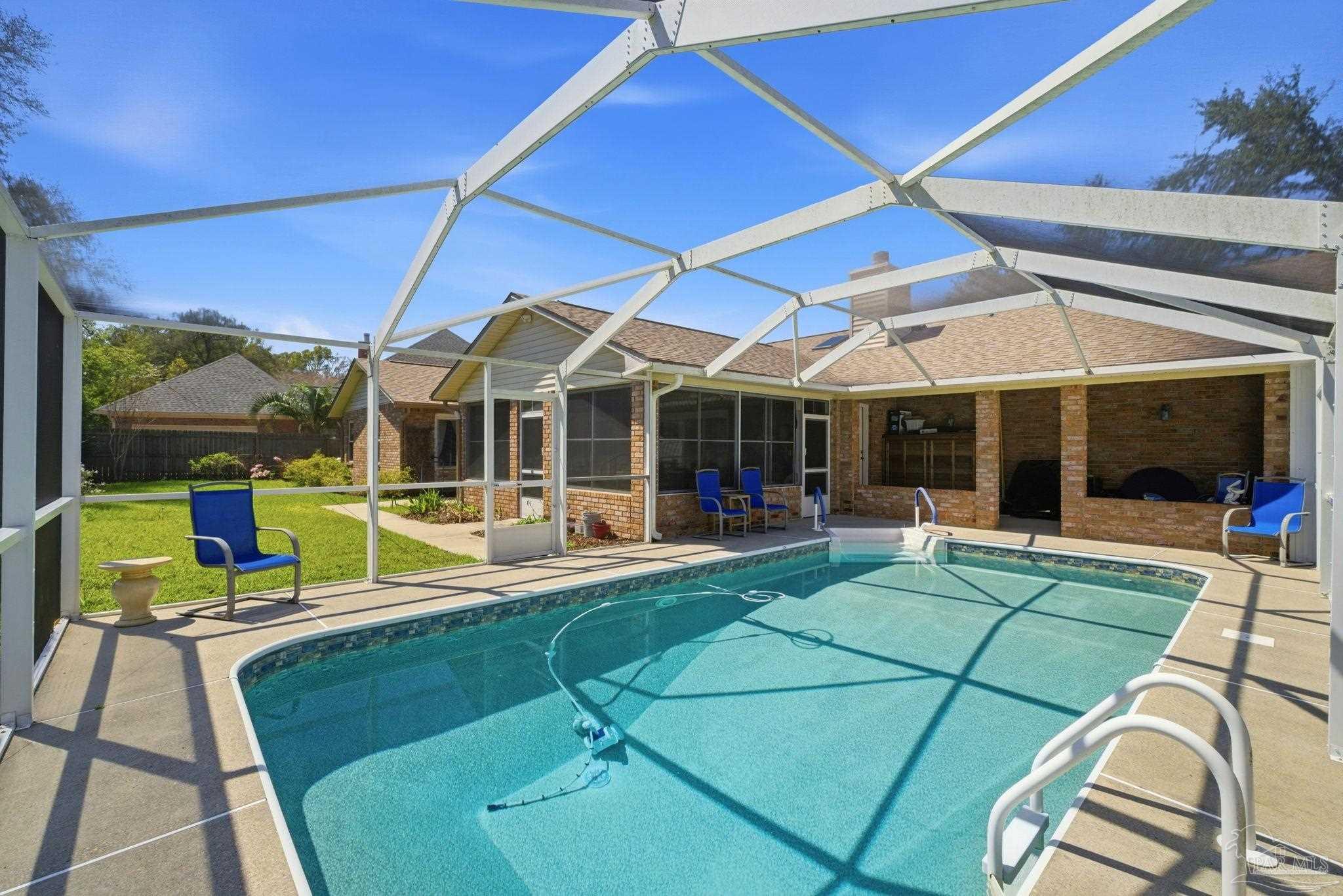6550 Chardonnay Pensacola, FL 32504 - Photo 36 of 42 a view of a patio with a table and chairs under an umbrella