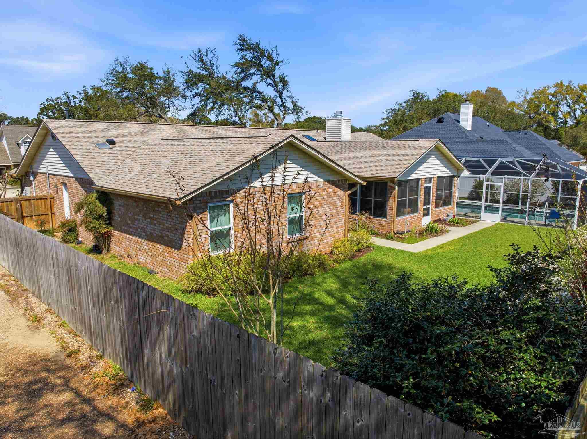 6550 Chardonnay Pensacola, FL 32504 - Photo 41 of 42 a view of a house with a small yard and wooden fence