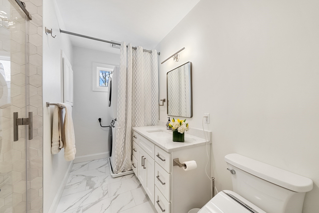 25 Fenwick Street, Unit 2 Somerville, MA 02145 - Photo 11 of 22 a bathroom with a sink a toilet and a mirror