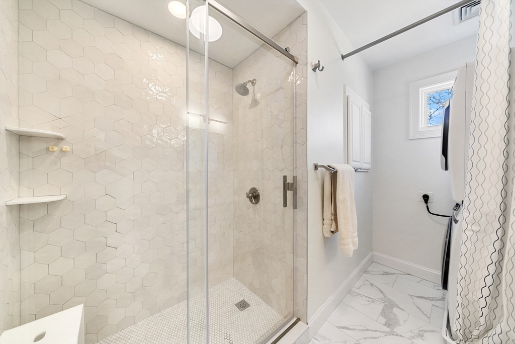 25 Fenwick Street, Unit 2 Somerville, MA 02145 - Photo 12 of 22 a bathroom with a shower and a glass door