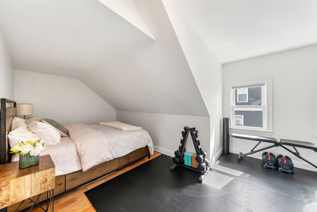 25 Fenwick Street, Unit 2 Somerville, MA 02145 - Photo 14 of 22 a bed room with a bed and a chair