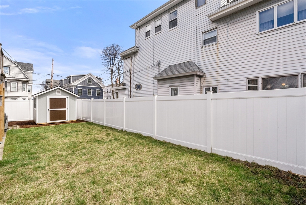 25 Fenwick Street, Unit 2 Somerville, MA 02145 - Photo 17 of 22 a view of a white house in front of a yard