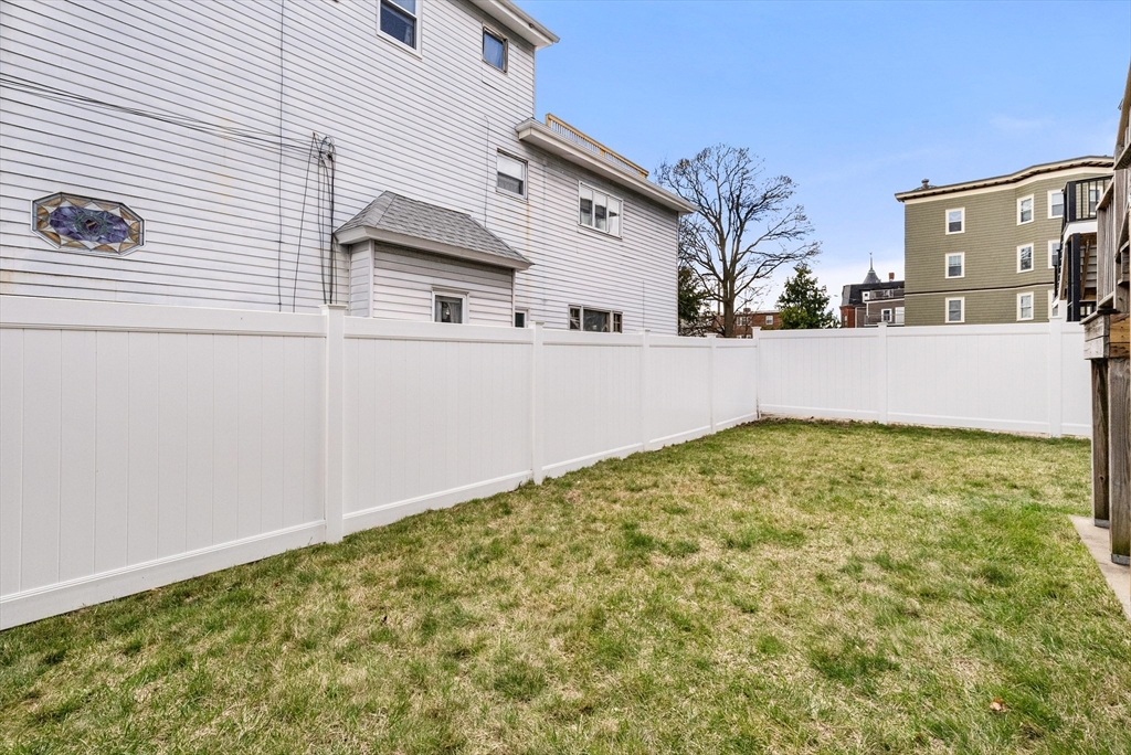 25 Fenwick Street, Unit 2 Somerville, MA 02145 - Photo 18 of 22 a view of a white house with a large park