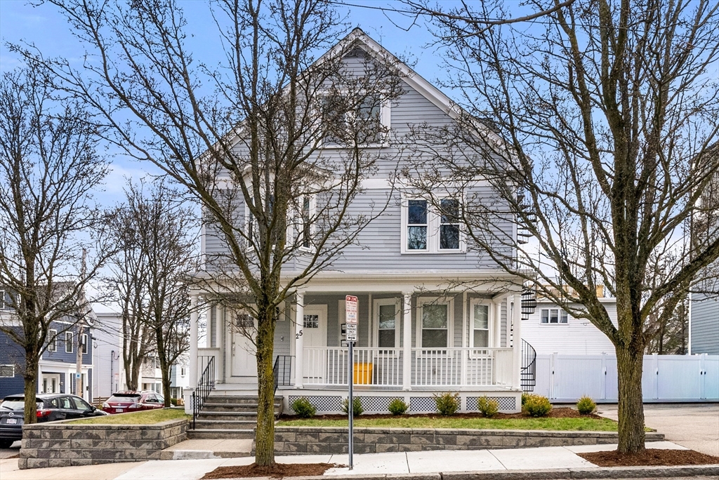 25 Fenwick Street, Unit 2 Somerville, MA 02145 - Photo 19 of 22 a front view of residential houses with yard and trees