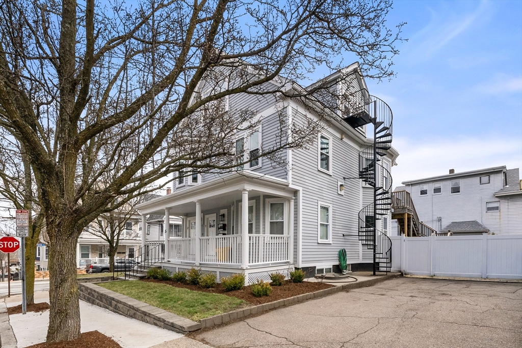 25 Fenwick Street, Unit 2 Somerville, MA 02145 - Photo 20 of 22 a front view of a house with a yard
