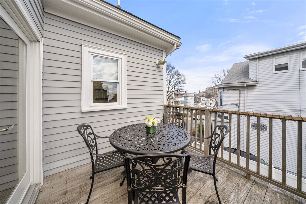 25 Fenwick Street, Unit 2 Somerville, MA 02145 - Photo 5 of 22 a table and chairs in front of a house