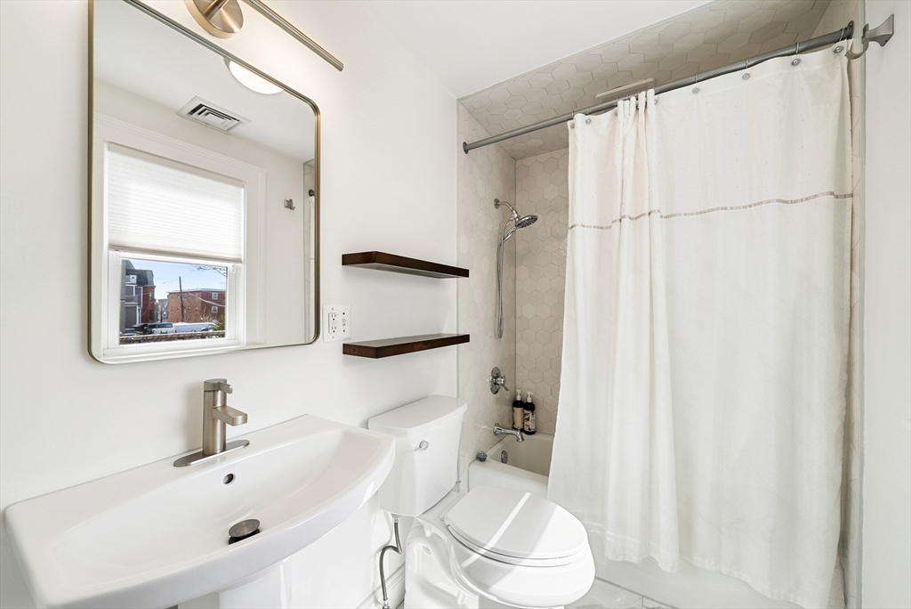 25 Fenwick Street, Unit 2 Somerville, MA 02145 - Photo 6 of 22 a bathroom with a sink a toilet and a mirror