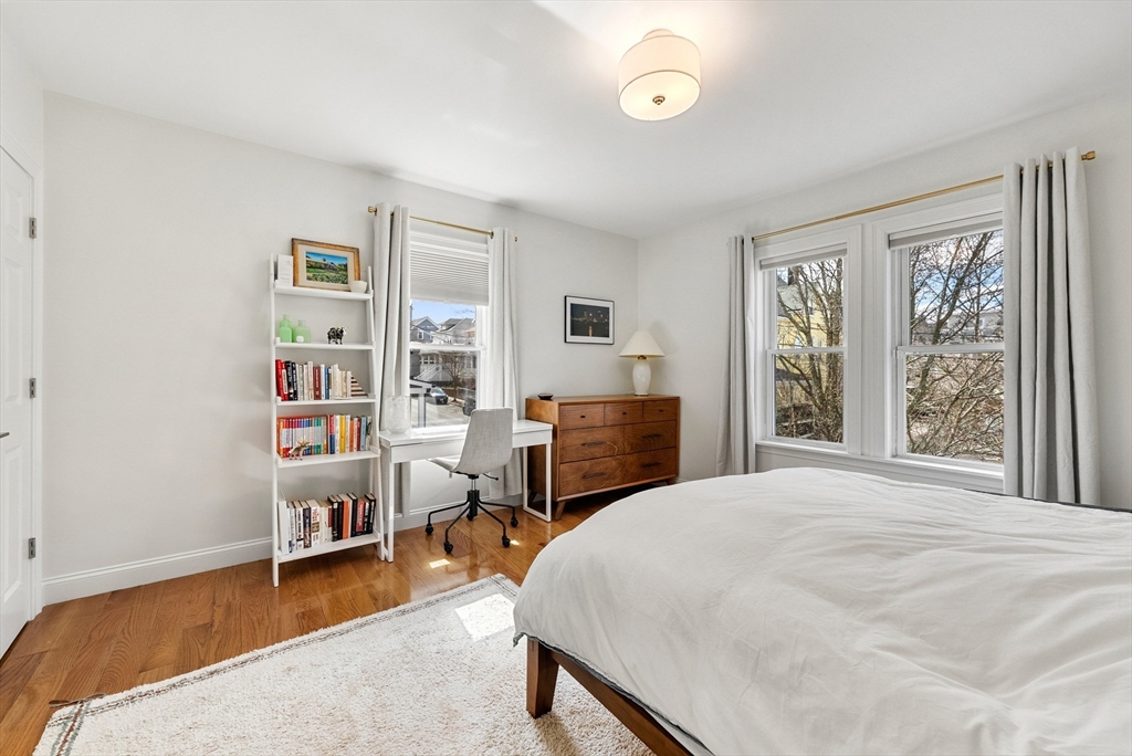 25 Fenwick Street, Unit 2 Somerville, MA 02145 - Photo 8 of 22 a bed room with a bed and a chair