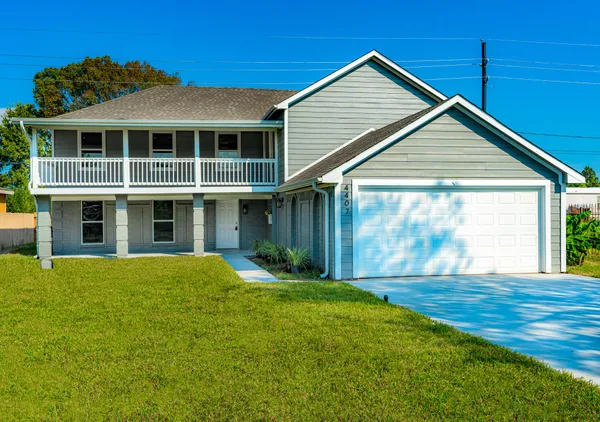 a front view of a house with yard and porch