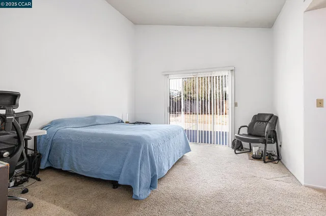 a bedroom with a bed and a chair