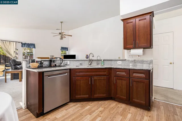 a bathroom with a granite countertop sink a toilet and a bathtub
