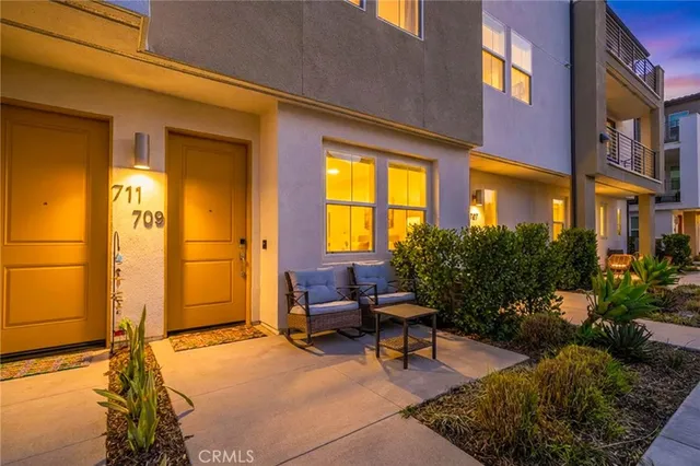 a building outdoor space with patio furniture and potted plants