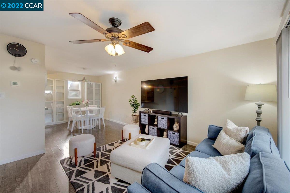 a living room with furniture a rug and a flat screen tv