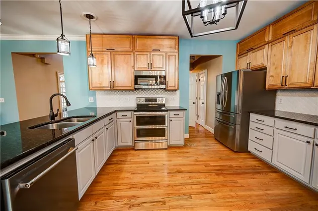 a view of a dining room with furniture wooden floor and chandelier