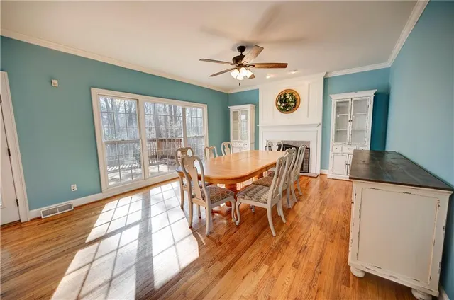 a spacious en suite bathroom with a double vanity sink a toilet a mirror and shower