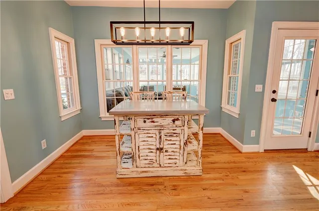 a spacious bathroom with a granite countertop sink and a mirror