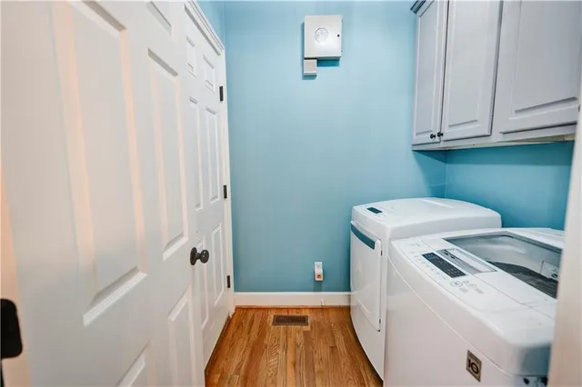 a spacious bedroom with a bed and a chandelier