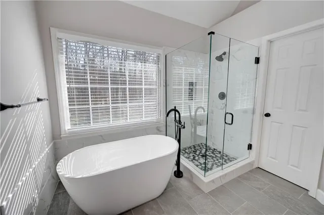 a view of empty room with wooden floor and fence