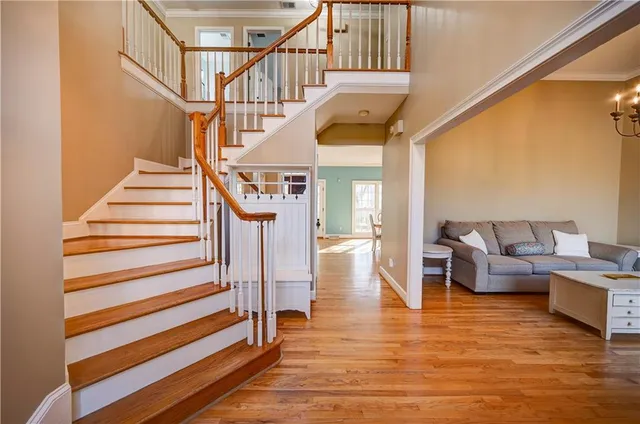 a living room with furniture and a chandelier