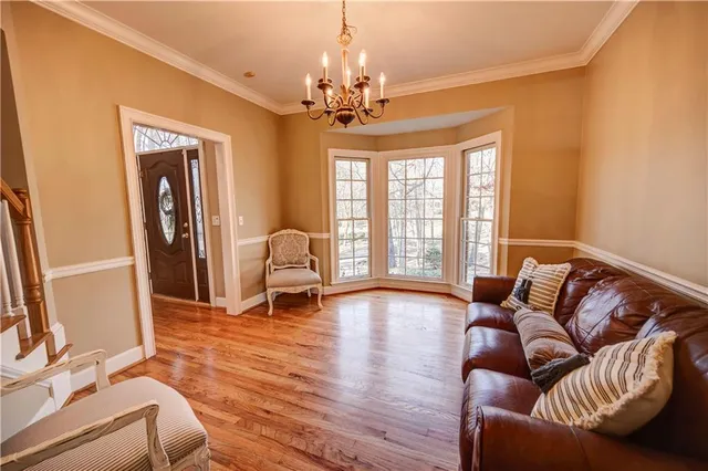 a kitchen with stainless steel appliances granite countertop a sink a stove and refrigerator