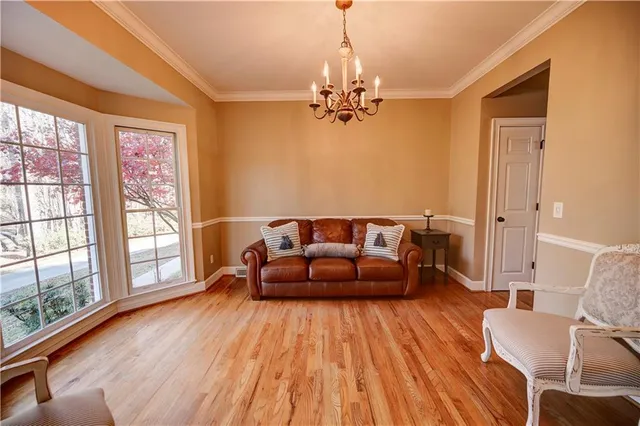 a large kitchen with stainless steel appliances granite countertop a stove a sink dishwasher and a wooden floor