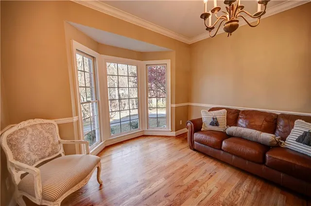 a kitchen with stainless steel appliances granite countertop a sink a window and cabinets